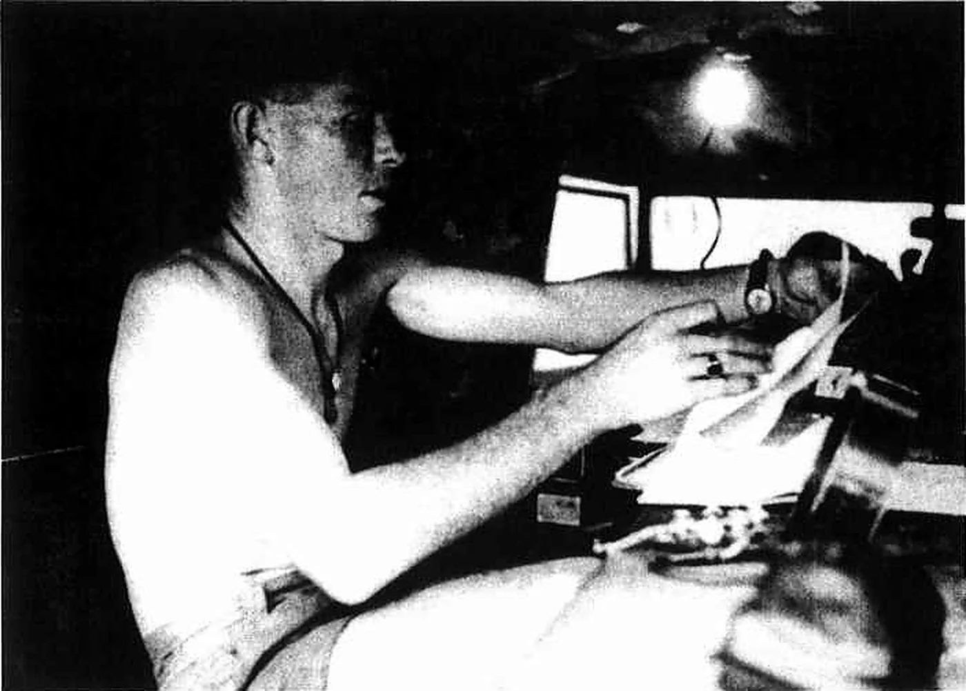 A signaller operating a radio set in the back of a Land Rover